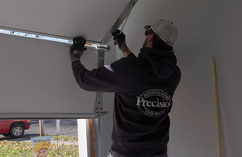 Technician Repairing Garage Door