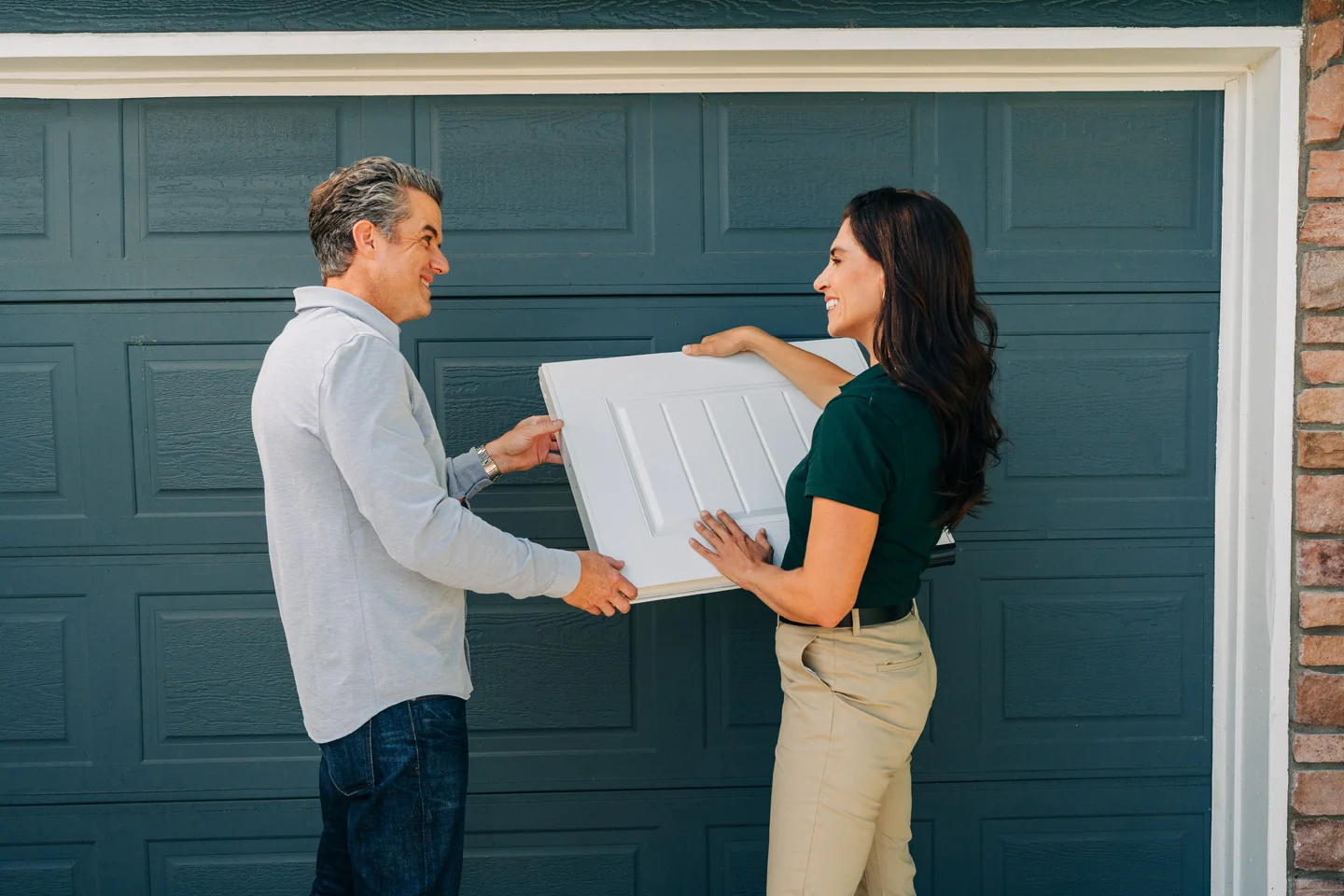 Garage door sales technician showing a panel design for energy efficient garage doors