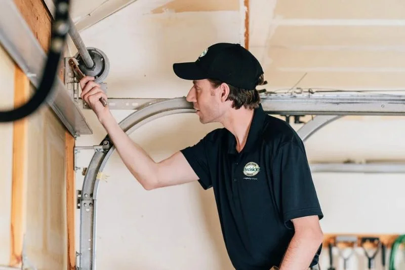 Technician inspecting a garage door Technician inspecting a garage door