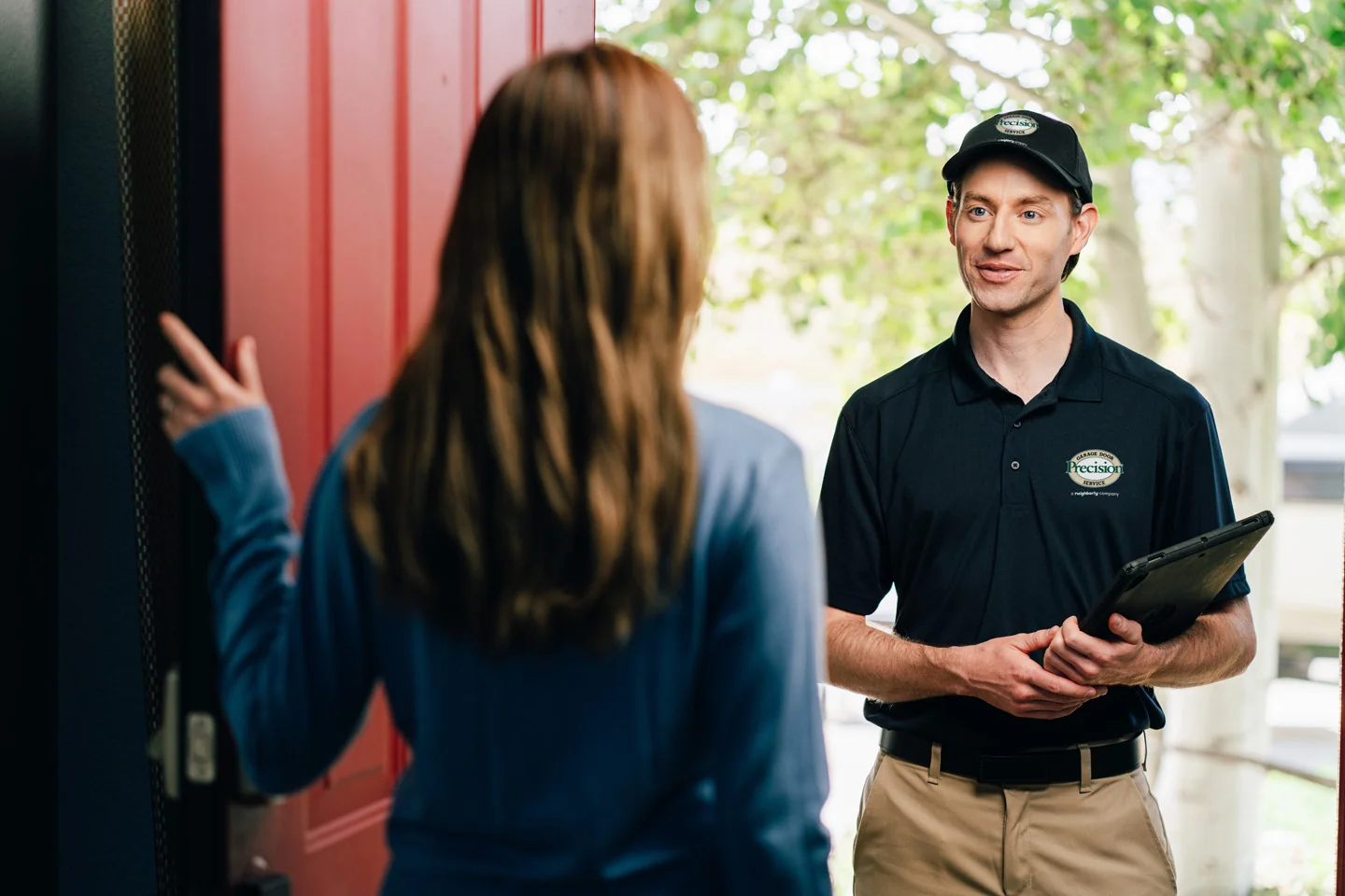 Garage door repair technician at customer's home