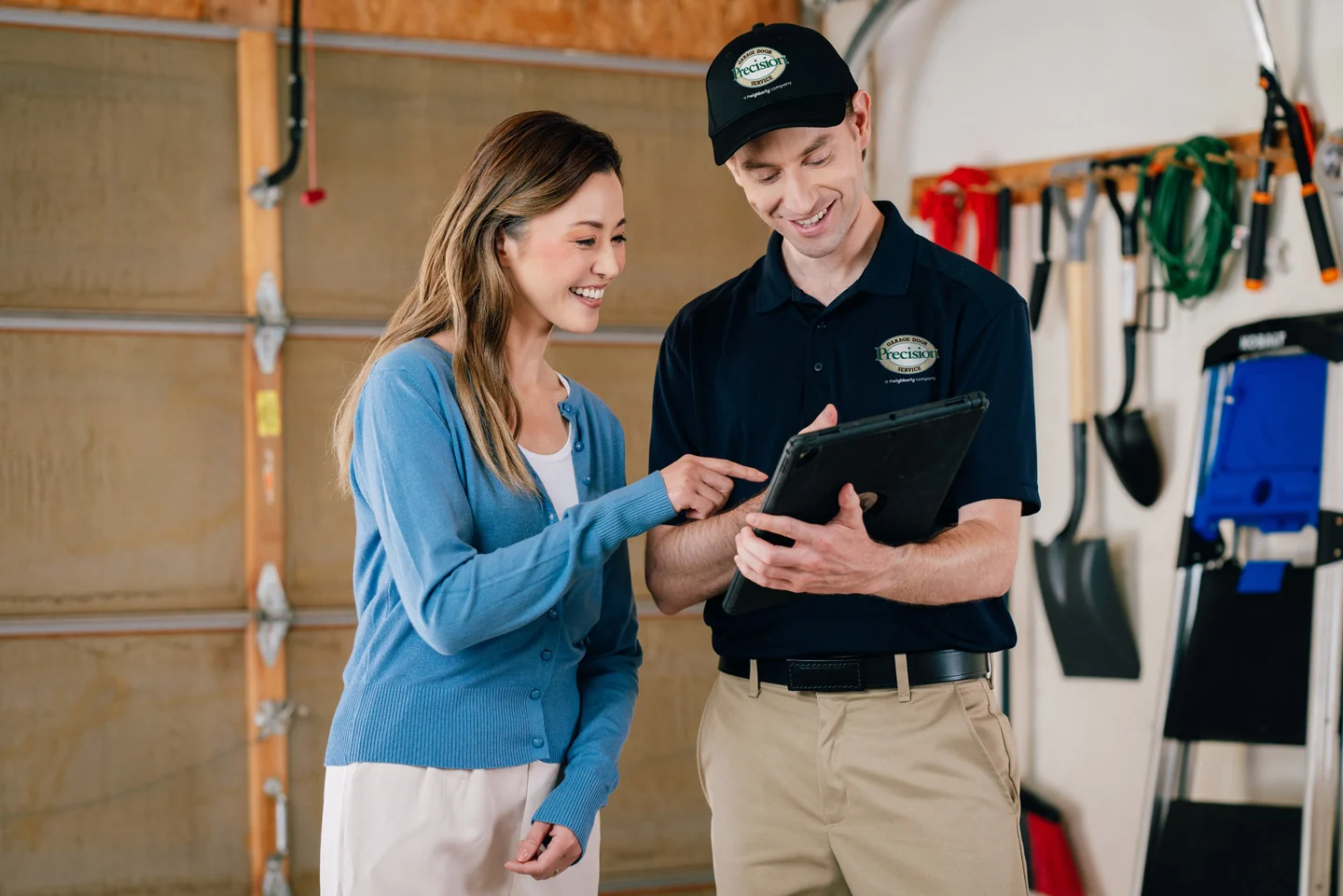 Precision Garage Door repair technician with a customer Precision Garage Door repair technician with a customer