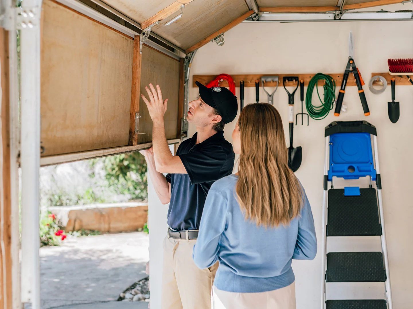 Precision Garage Door technician helping customer with garage door repairs