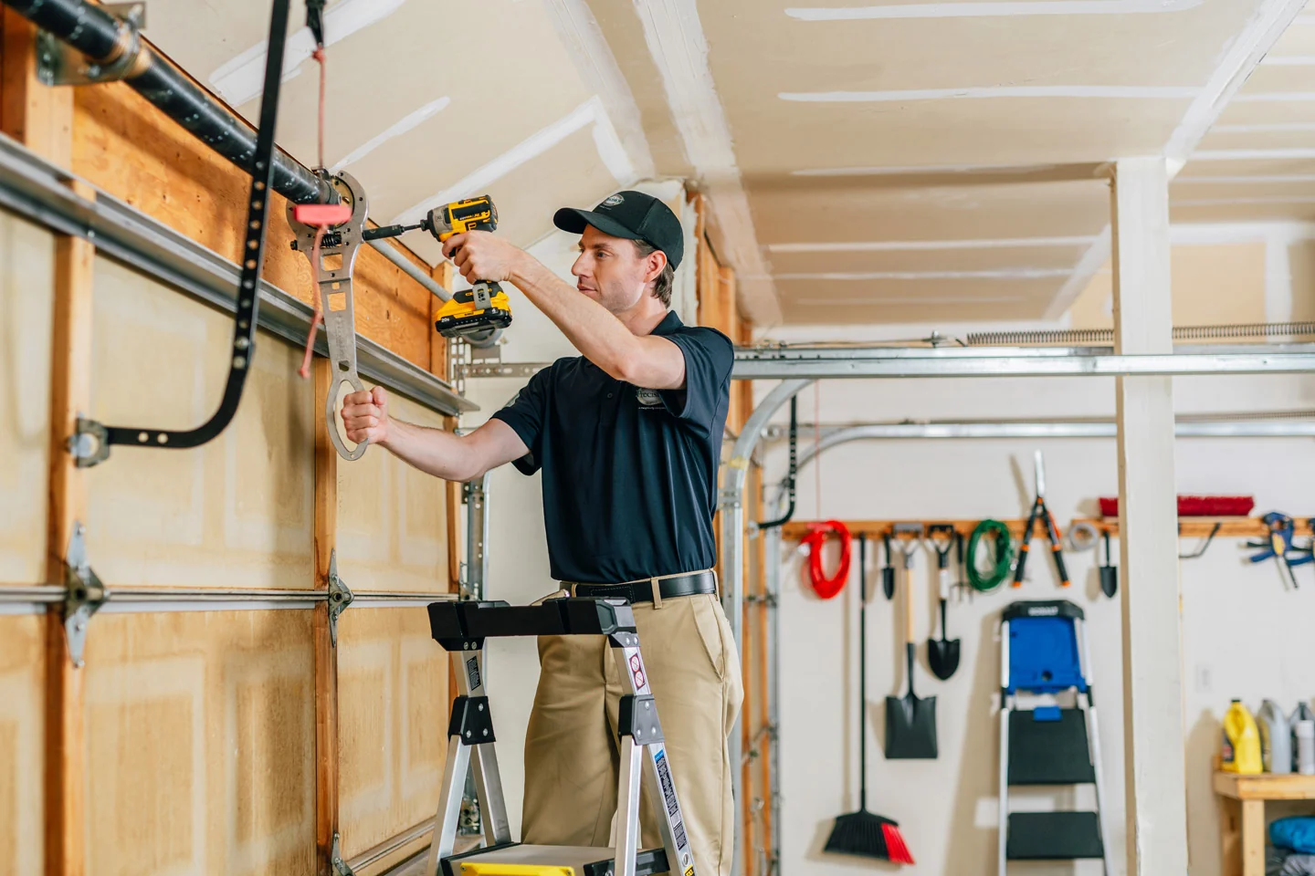 Precision Garage Door technician repairing a garage door center bearing