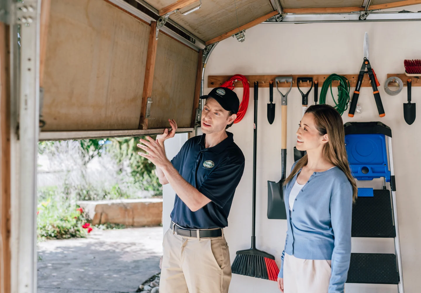 Precision technician inspecting an insulated garage door